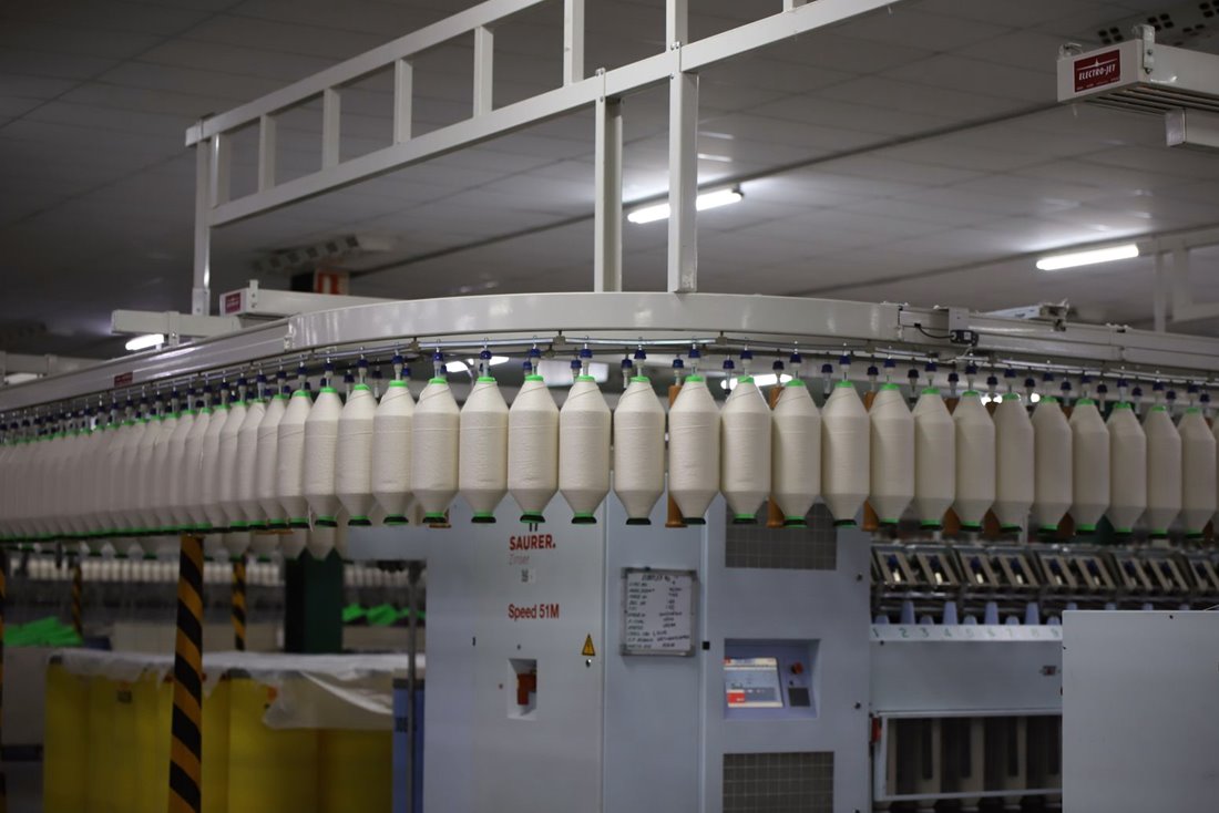 Cotton being woven on a loom